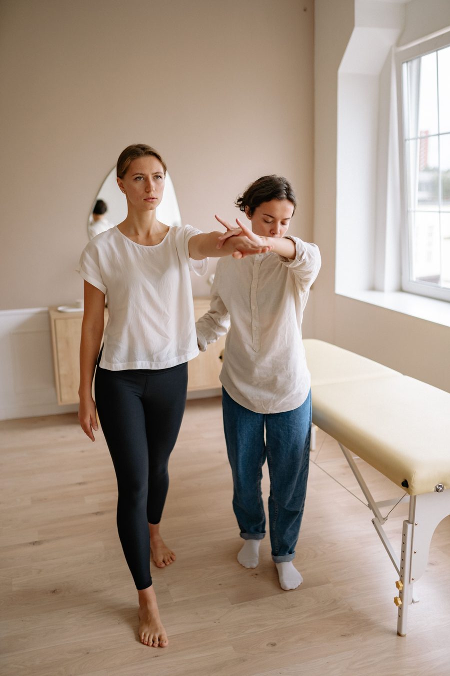 Therapist conducting a whole-body assessment on the therapy table