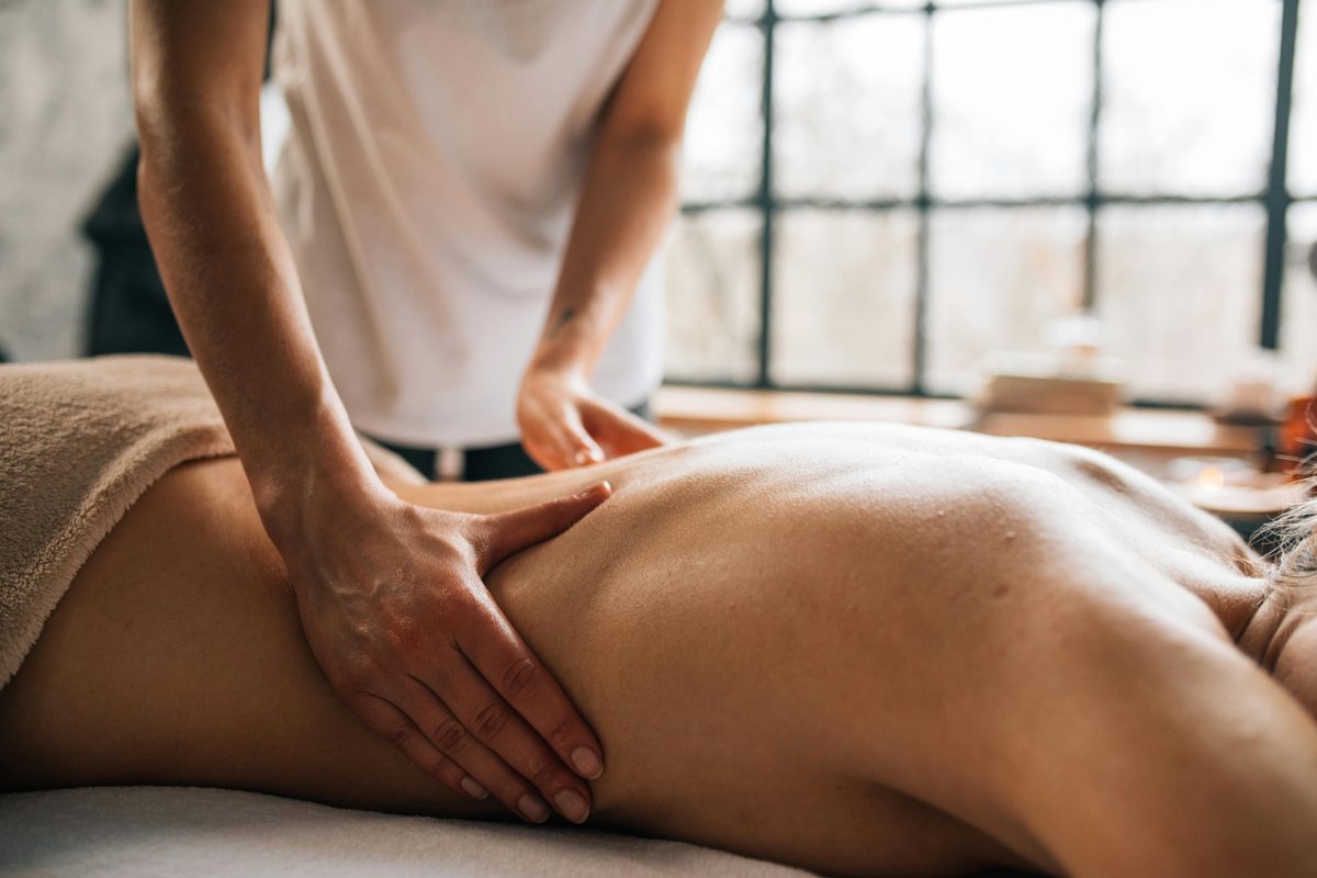 Practitioner performing gentle Bowen therapy on a patient